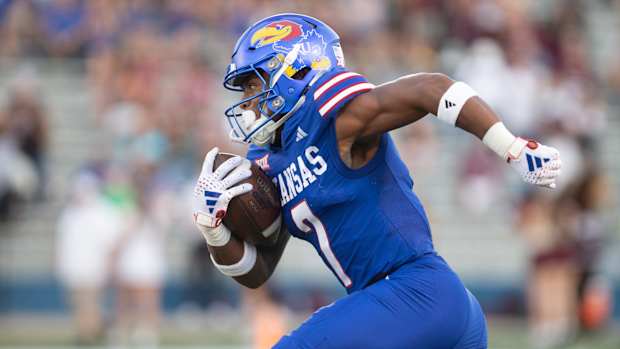 Kansas redshirt junior wide reciever Trevor Wilson (7) takes off after a punt return in the first quarter of Friday's game against Missouri State inside David Booth Kansas Memorial Stadium.  